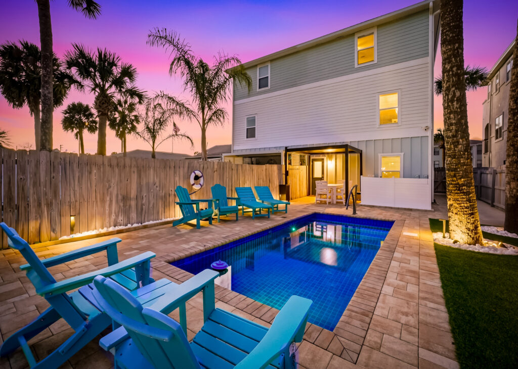Endless Summer rental with a private pool and turquoise chairs at sunset